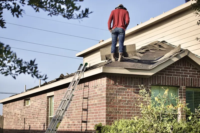 Professional roofer working on a residential roof in Riverside